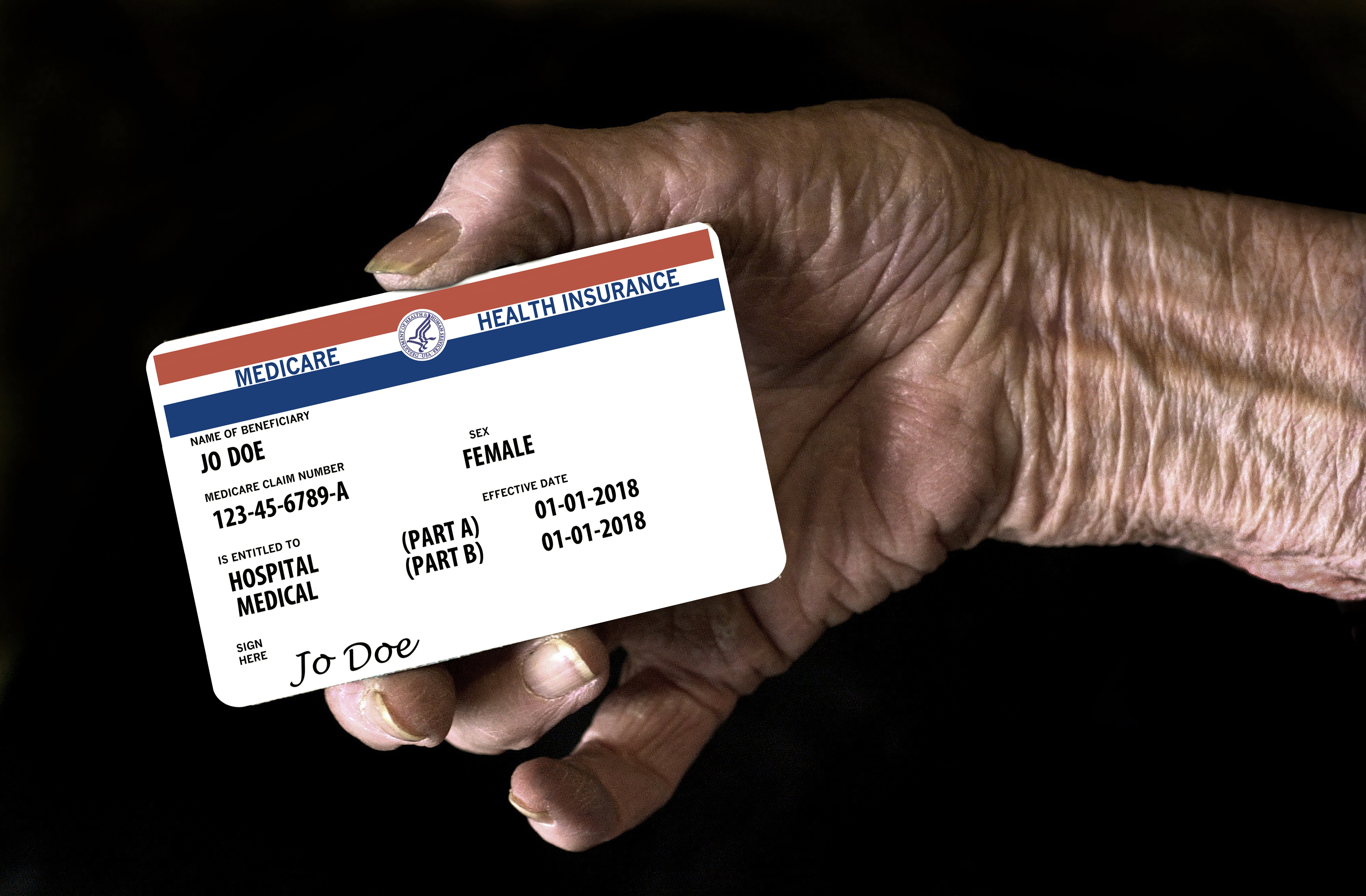 A Medicare enrollee holds their red, white, and blue card.
